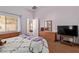 Tranquil bedroom with wood floors and a view into the dining area at 45068 W Alamendras St, Maricopa, AZ 85139
