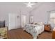 Bright main bedroom with vaulted ceiling, wood floors, and ensuite bathroom at 45068 W Alamendras St, Maricopa, AZ 85139