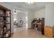 An office area with wood-look flooring and a view into the living room at 45068 W Alamendras St, Maricopa, AZ 85139