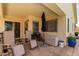 Covered patio featuring outdoor furniture and a barbecue grill, perfect for outdoor gatherings and relaxation at 45068 W Alamendras St, Maricopa, AZ 85139