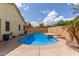 Backyard with a pristine blue swimming pool surrounded by lush greenery and ample space for outdoor activities at 45068 W Alamendras St, Maricopa, AZ 85139