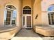 Charming front entrance featuring arched windows and a decorative security door, adding character and security at 4867 E Windstone Trl, Cave Creek, AZ 85331