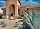 Beautiful home featuring arched entryways and desert landscaping, creating an inviting and unique outdoor space at 4867 E Windstone Trl, Cave Creek, AZ 85331