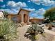 Desert landscaped front exterior featuring an arched entry and attached garage, adding curb appeal and functionality at 4867 E Windstone Trl, Cave Creek, AZ 85331