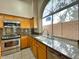 Kitchen with granite countertops, stainless steel appliances, and a large arched window at 4867 E Windstone Trl, Cave Creek, AZ 85331