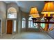 Open living room with arched windows, front door, and a chandelier at 4867 E Windstone Trl, Cave Creek, AZ 85331