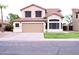 Charming two-story home featuring a tile roof, neutral stucco, and a well-manicured lawn at 488 W Harvard Ave, Gilbert, AZ 85233