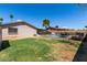 Large backyard with a well-kept lawn, refreshing pool, and patio for outdoor relaxation and enjoyment at 5221 W Garden Dr, Glendale, AZ 85304