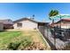 Expansive backyard with a grassy lawn, covered patio, and pool, creating an ideal outdoor retreat at 5221 W Garden Dr, Glendale, AZ 85304