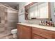 Well-maintained bathroom featuring a vanity with ample storage and a glass-enclosed shower at 5221 W Garden Dr, Glendale, AZ 85304