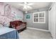 Bedroom with a crib, mermaid mural, white trim window, and light tile flooring at 5221 W Garden Dr, Glendale, AZ 85304