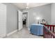 Bedroom with a door to another room and a changing table beside a grey wall at 5221 W Garden Dr, Glendale, AZ 85304