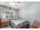 Traditional bedroom featuring a single bed, ceiling fan, and natural light from the window with louvered blinds at 5221 W Garden Dr, Glendale, AZ 85304
