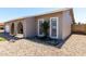 Side view of home's front exterior features landscaped accents, an arched entryway and shuttered windows at 5221 W Garden Dr, Glendale, AZ 85304
