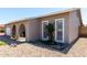 Well-maintained home front exterior with stone landscaping, arched entrance, and shuttered windows at 5221 W Garden Dr, Glendale, AZ 85304