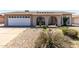 Charming single-story home featuring a well-maintained front yard, a two-car garage, and arched front entryway at 5221 W Garden Dr, Glendale, AZ 85304