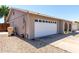 Exterior of the home showing a large, two-car garage and side yard with easy access at 5221 W Garden Dr, Glendale, AZ 85304
