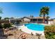 Sparkling pool with patio furniture and desert landscaping offering a backyard oasis at 5221 W Garden Dr, Glendale, AZ 85304