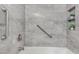 Tiled shower features grab bars, built in niches, and gray tile at 5221 W Garden Dr, Glendale, AZ 85304