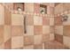 Close-up of tiled shower featuring a grab bar, corner seat, and two tiled niches with decorative plants at 5221 W Garden Dr, Glendale, AZ 85304