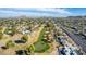 Birds-eye view of a green golf course surrounded by houses in a well-maintained community with mountain views at 544 W Thunderbird Rd, Phoenix, AZ 85023