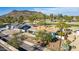 Aerial view of a charming home with a lush front yard and mountain views in the distance at 544 W Thunderbird Rd, Phoenix, AZ 85023