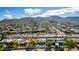 An aerial view captures houses, a pool, and a road leading to scenic mountains at 544 W Thunderbird Rd, Phoenix, AZ 85023