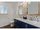 Bathroom featuring a double sink vanity with unique backsplash and charming framed mirrors, exuding style at 544 W Thunderbird Rd, Phoenix, AZ 85023