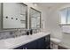Bathroom features dual sinks with stylish mirrors and blue patterned backsplash at 544 W Thunderbird Rd, Phoenix, AZ 85023