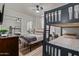 Bedroom featuring bunk beds, sleek mirrors, and neutral walls creating a comfortable and stylish living space at 544 W Thunderbird Rd, Phoenix, AZ 85023
