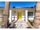 Close up of a bright yellow front door framed by desert landscaping at 544 W Thunderbird Rd, Phoenix, AZ 85023