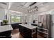 Modern kitchen with stainless steel appliances, an island, and pendant lighting at 544 W Thunderbird Rd, Phoenix, AZ 85023