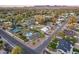 Scenic aerial shot capturing the neighborhood, palm trees, and private backyard pools at 5975 E Larkspur Dr, Scottsdale, AZ 85254