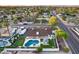 Stunning aerial view of the property featuring a pool, putting green, and outdoor gazebo, set against a backdrop of lush landscaping at 5975 E Larkspur Dr, Scottsdale, AZ 85254