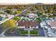 Beautiful aerial shot of a home with a pool, putting green, and gazebo in a neighborhood with mountain views at 5975 E Larkspur Dr, Scottsdale, AZ 85254
