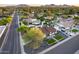 Expansive aerial view showcasing the property's pool, gazebo, putting green, and well-maintained landscaping in a serene neighborhood setting at 5975 E Larkspur Dr, Scottsdale, AZ 85254