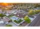 Stunning aerial view of a private backyard oasis with a pool, mini-golf, and manicured landscaping at 5975 E Larkspur Dr, Scottsdale, AZ 85254