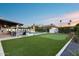This beautiful backyard offers a built in pool, lounge chairs, and a putting green, perfect for entertaining at 5975 E Larkspur Dr, Scottsdale, AZ 85254