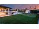 Resort-style backyard with pool, spa, putting green, and covered lounge area for ultimate relaxation at 5975 E Larkspur Dr, Scottsdale, AZ 85254