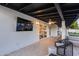 An amazing covered patio with lighting, ceiling fan, TV and comfy chairs provides the perfect space for outdoor relaxing at 5975 E Larkspur Dr, Scottsdale, AZ 85254