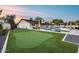 This large manicured backyard features a swimming pool, putting green, manicured landscaping and lounge area at 5975 E Larkspur Dr, Scottsdale, AZ 85254