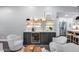 Home wet bar features open shelving, wine fridge, accent lighting, and stylish decor at 5975 E Larkspur Dr, Scottsdale, AZ 85254