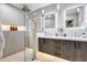 Modern bathroom featuring a glass-enclosed shower, double vanity, and sleek fixtures at 5975 E Larkspur Dr, Scottsdale, AZ 85254