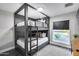 Unique gray bunkbeds with comfy mattresses next to a light-filled window at 5975 E Larkspur Dr, Scottsdale, AZ 85254