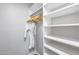 Spacious walk-in closet with ample shelving and a hanging robe at 5975 E Larkspur Dr, Scottsdale, AZ 85254
