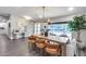 Bright dining room featuring a modern light fixture, stylish decor, and large windows, creating an inviting atmosphere at 5975 E Larkspur Dr, Scottsdale, AZ 85254