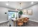 Inviting dining room featuring modern decor, a spacious table, and ample natural light from the window at 5975 E Larkspur Dr, Scottsdale, AZ 85254