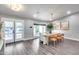 Bright dining room with a modern table, chairs, art and access to a patio through a glass door at 5975 E Larkspur Dr, Scottsdale, AZ 85254