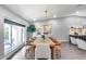 Elegant dining room with modern lighting, decor, and large windows allowing ample natural light at 5975 E Larkspur Dr, Scottsdale, AZ 85254