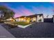 Charming single-story home featuring a beautifully landscaped front yard with a modern turf design at 5975 E Larkspur Dr, Scottsdale, AZ 85254